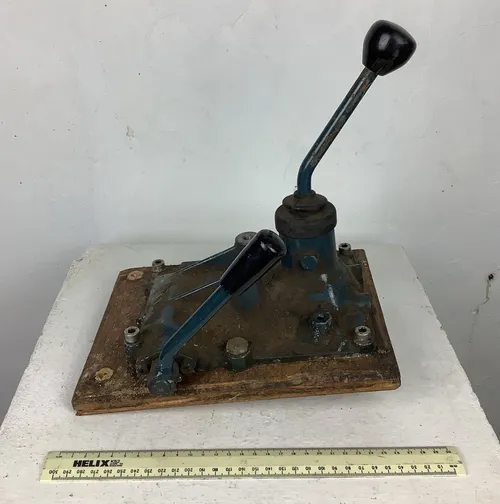 Blue and Black Industrial Metal Pump on Wooden Slab