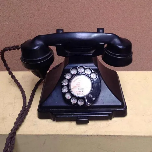black corded rotary dial telephone with flex cord