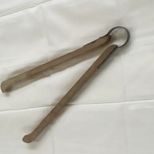 Period wooden tongs with metal hinge 