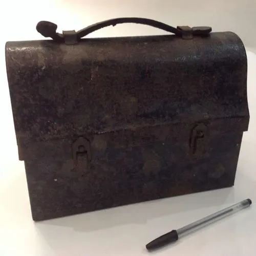 rusty lunch pail / box with well-worn leather strap
