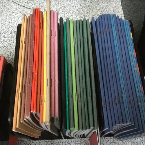 Quantity of miscellaneous coloured school jotters 