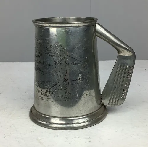 Metal tankard with engraved golf scene and golf club shaped handle