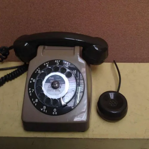 two tone brown rotary dial telephone with extra handset piece