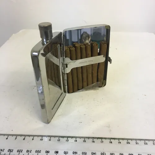 silver flask with decorative design and cigarette case