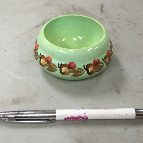 Small green ceramic pot with floral pattern 