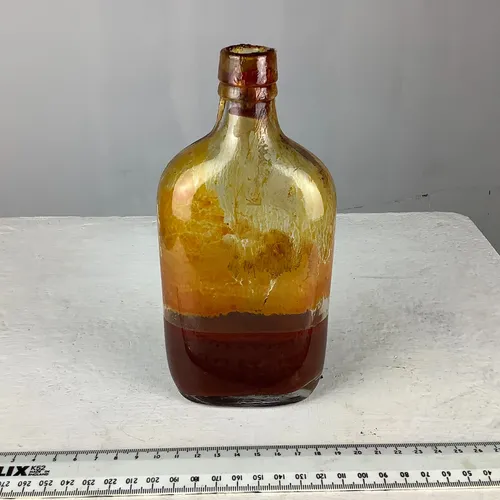 Period Yellow Glass Bottle with Mysterious Brown Liquid 
