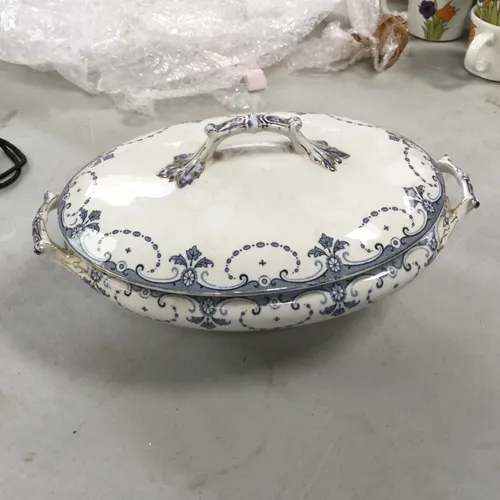 White china serving dish with blue decorative pattern with lid and handles