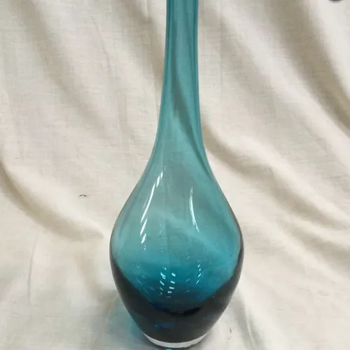 Tall light blue glass vase with thin neck