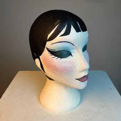Polystyrene female bust with black hair and makeup