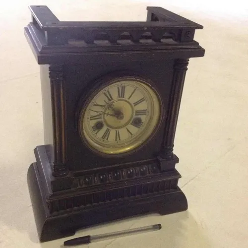 dark wood analogue shelf mantle clock with decorative base and top
