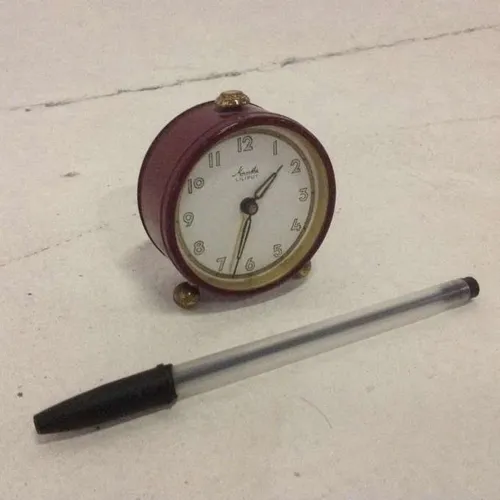 Mauthe Liliput red metal analogue clock with white face and glass face cover