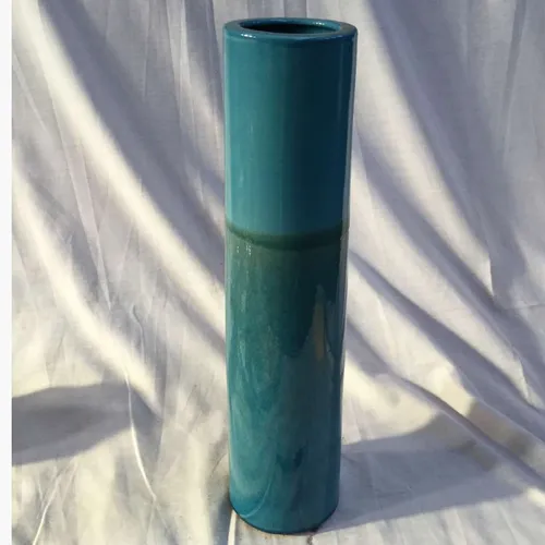 Tall blue/green cylindrical ceramic vase