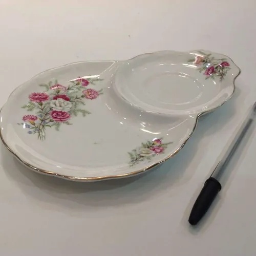 white ceramic combination side plate and cup saucer with pink floral design with gold trim