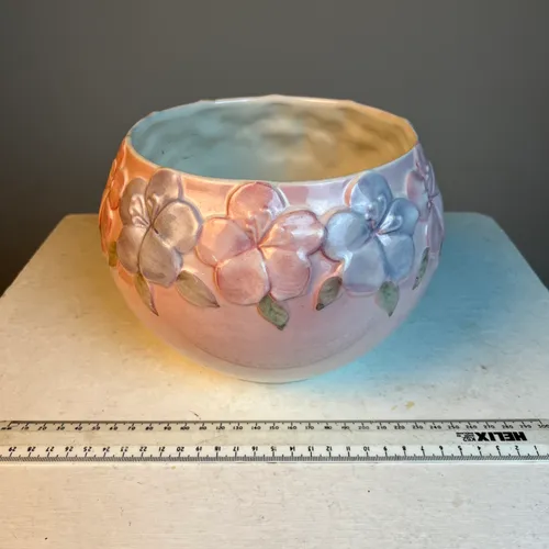 Glazed pink floral ceramic planter with pink and purple flowers