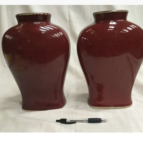 Pair deep red ceramic vases