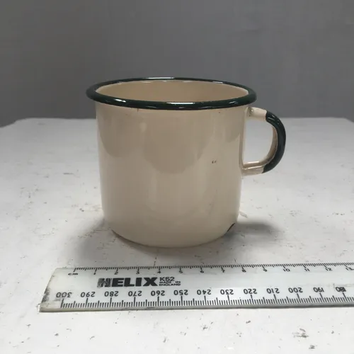 Cream period enamelware mug with green rim