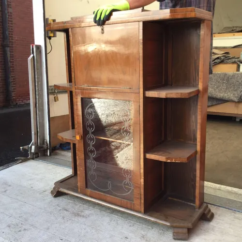 Dark wood unit with shelves, glass door and drop down cupboard