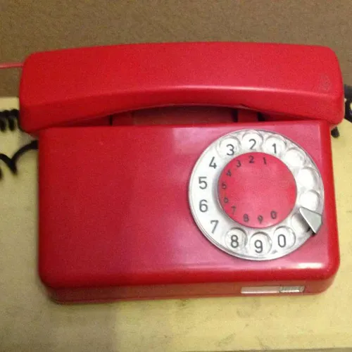 red Telkom corded rotary dial telephone