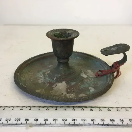 Wax covered brass chamberstick