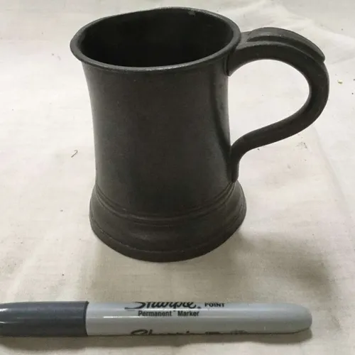 Dark, slight concave, metal tankard