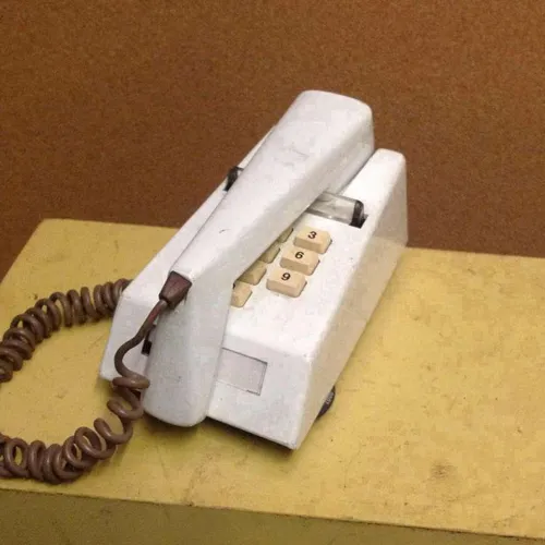 white corded trimphone with push buttons