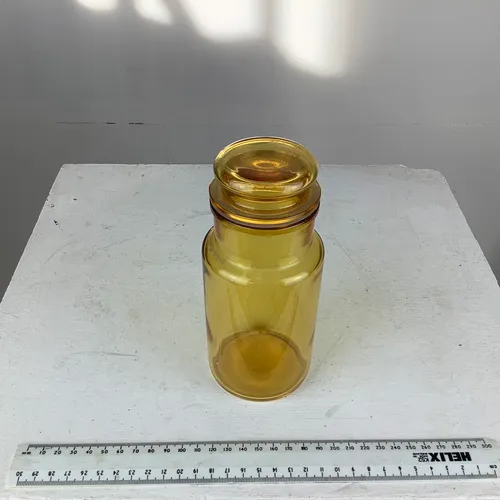 Yellow glass bottle with glass lid