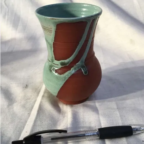 Terracotta vase with blue paint spill detail 