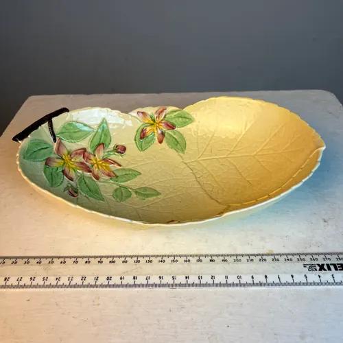 Yellow leaf shaped ceramic ware dish with painted flower detail