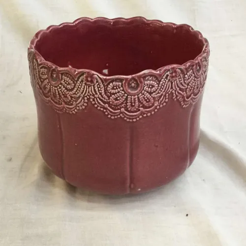 Pink ceramic planter with white lace like detail 