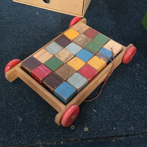 Child’s pull along wooden cart with coloured wooden blocks