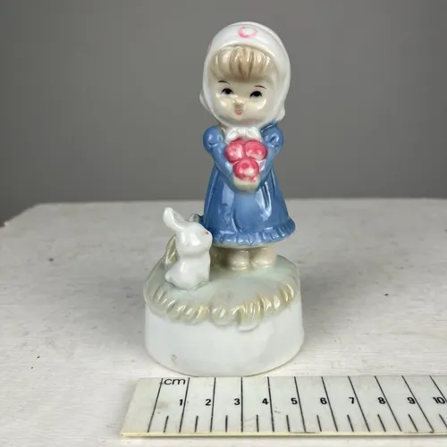 Child Carrying Apples with Rabbit Ornament