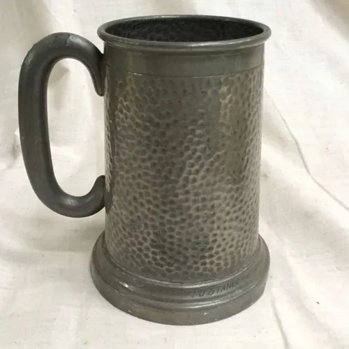 Tall metal tankard (with indents and curved C shaped handle)