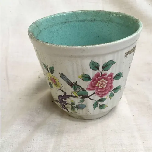 White plant pot with flower and bird painted details