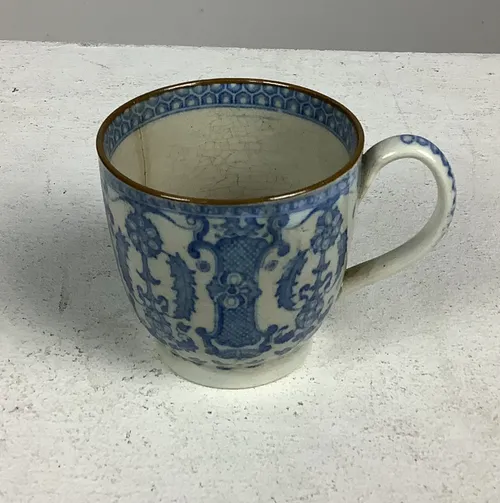 Small White and Blue Patterned China Cup