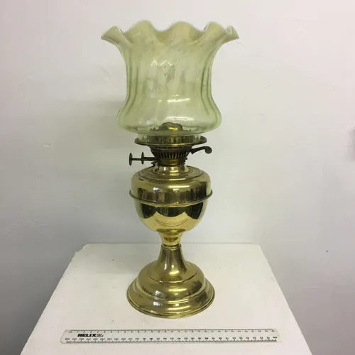 Period gold paraffin lamp with green tinted glass shade