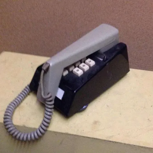 black and grey corded trimphone with push buttons