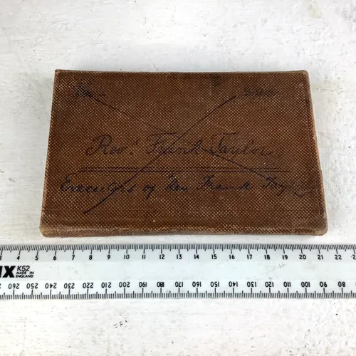 period dark tan textured notebook with fastening cover