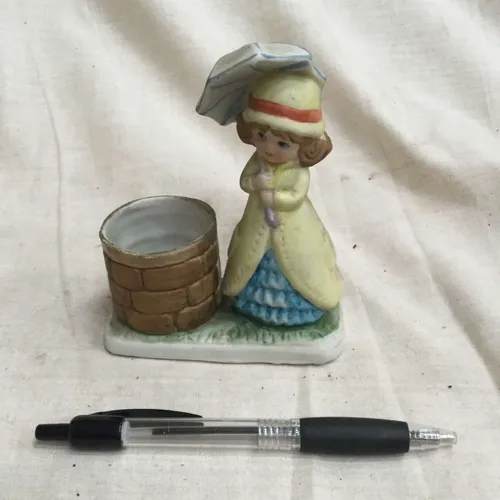 “Lady with umbrella by a well” ceramic ornament 