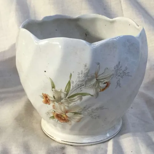 White plant pot with scalloped edge and floral detail 