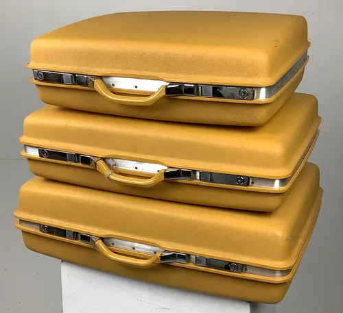 Set of three mustard coloured suitcases