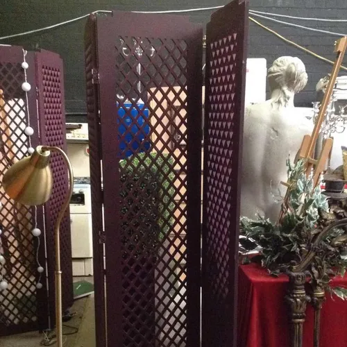 Three part hinged partition screen, purple wood with lattice cut out design