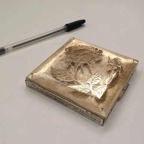 square powder compact with rose design