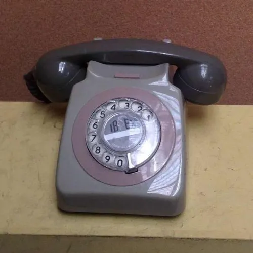 grey and brown rotary dial corded telephone