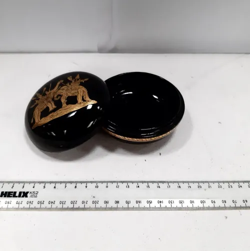 Black plastic pot with gold elephant design