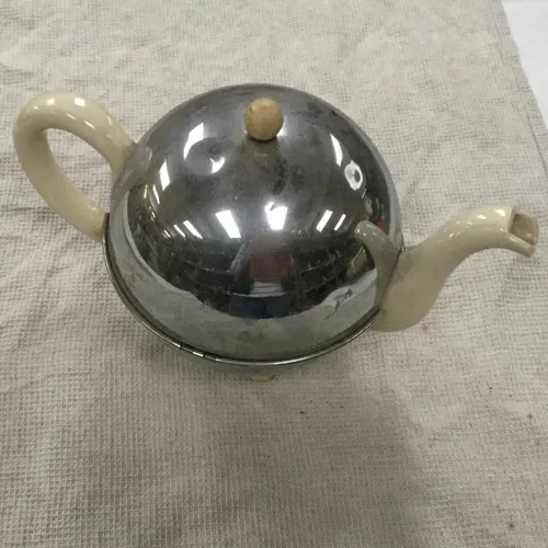 Metal teapot with cream handle and spout
