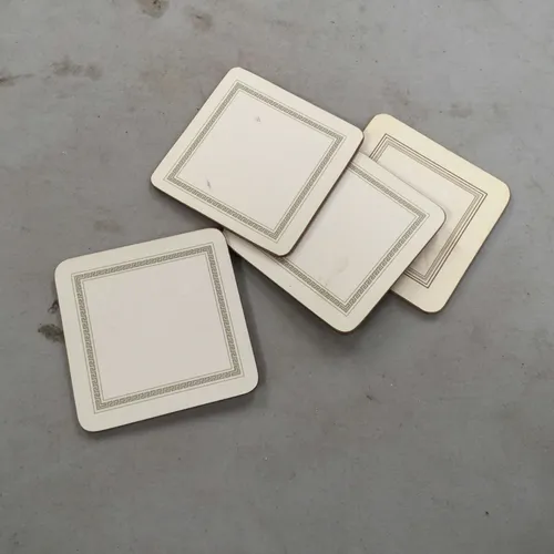 Set of four white coasters