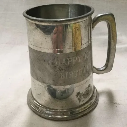 Polished metal tankard with “Happy Birthday” inscription 