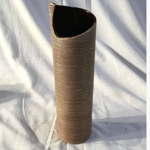 Tall brown cylindrical vase with engraved lines and shell like top