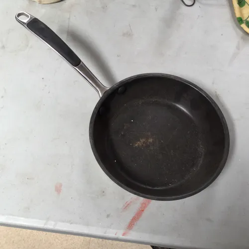 Small modern black and silver frying pan 