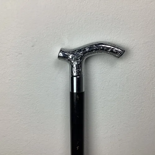 Black walking stick with silver engraved handle
